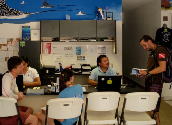 A view of the Blue Magic Scuba front desk with customers.